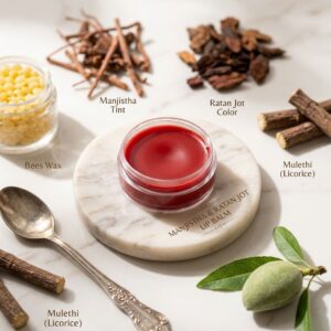 The balm is surrounded by Mulethi sticks, Ratan Jot root, and a small golden spoon of Desi Ghee on a clean, cream-colored textured background.