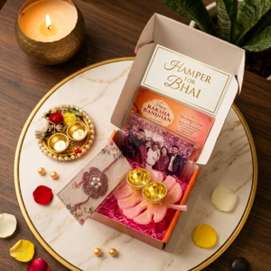 An open, aesthetically styled Rakhi special gift box showcasing a handmade crochet Rakhi, a glossy resin roli chawal platter, a quirky fridge magnet, and decorative accents arranged neatly inside.
